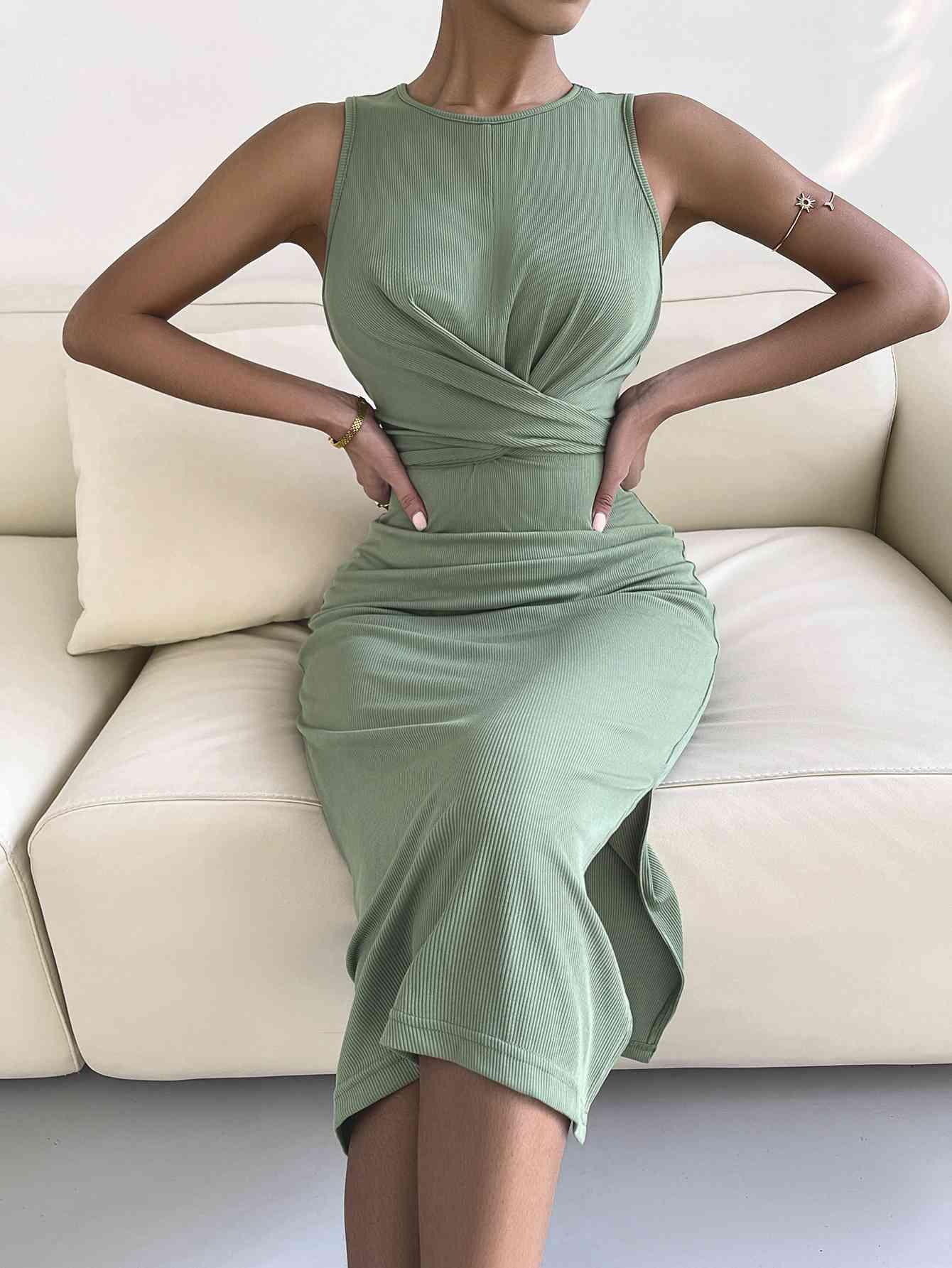 a woman in a green dress sitting on a couch