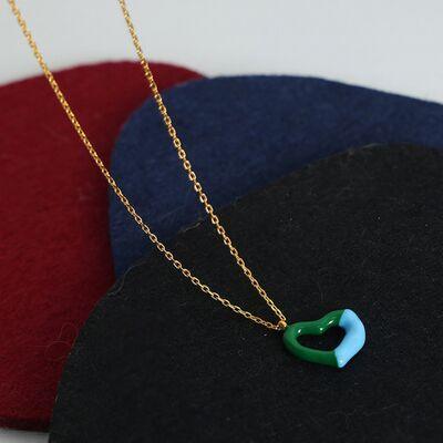 a hat with a green and blue pendant on it