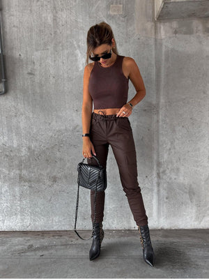 a woman in a brown top and brown pants