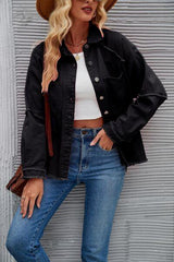 a woman wearing a hat and jeans leaning against a wall