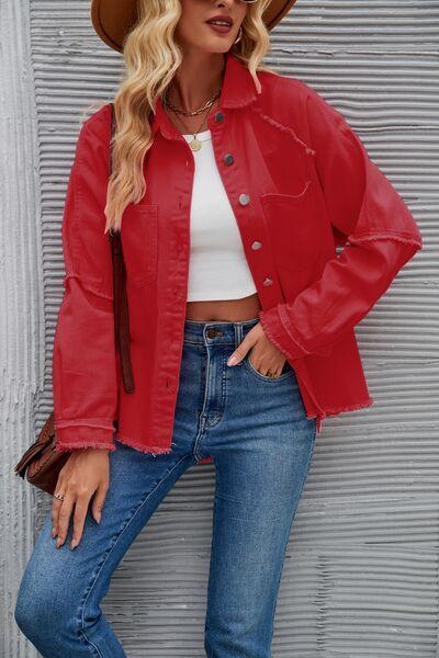 a woman wearing a red jacket and jeans