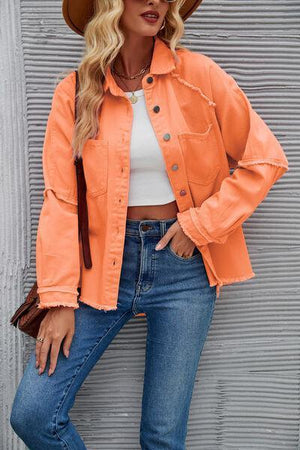 a woman wearing an orange jacket and hat