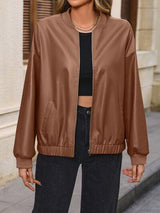 a woman wearing a brown leather bomber jacket