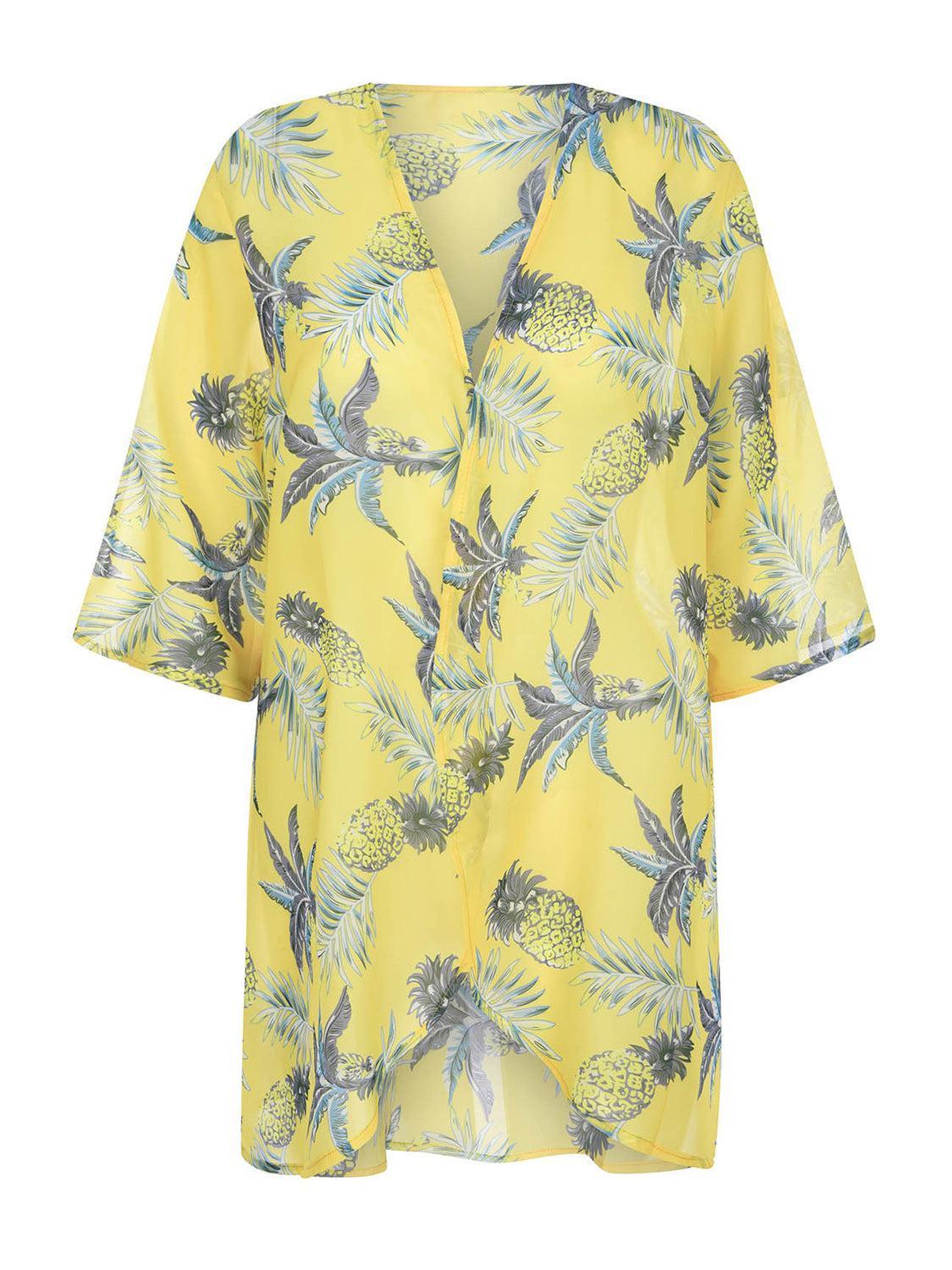 a yellow top with pineapples on it