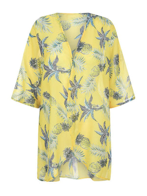 a yellow top with pineapples on it