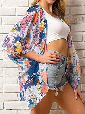 a woman in a white top and floral kimono