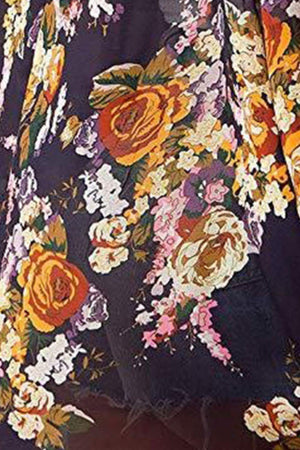 a close up of a person wearing a dress with flowers on it