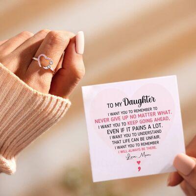 a person holding a card with a ring on it