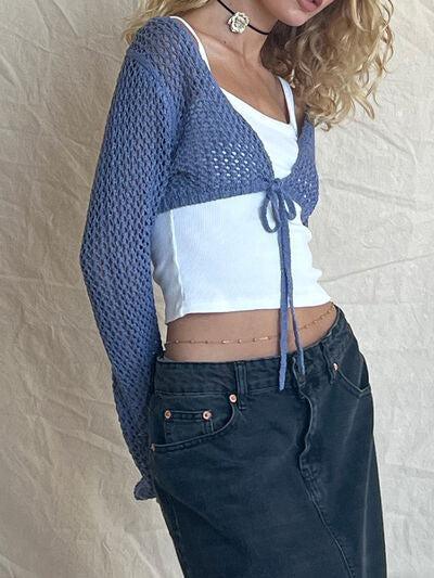a woman posing for a picture wearing a blue and white top
