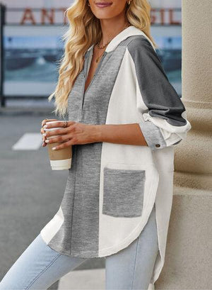 a woman leaning against a pillar with a cup of coffee