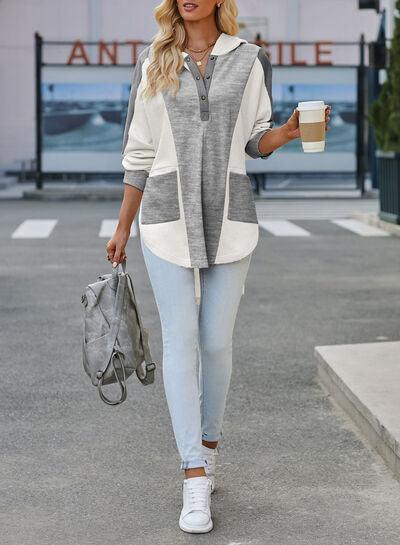 a woman walking down a street holding a cup of coffee