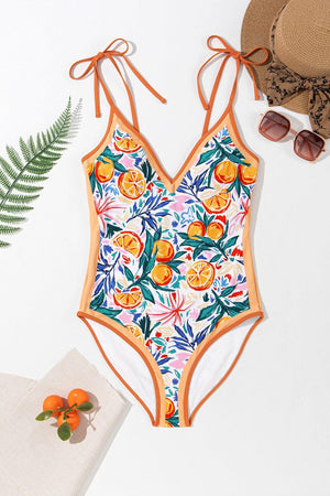 a women's one piece swimsuit with oranges on it