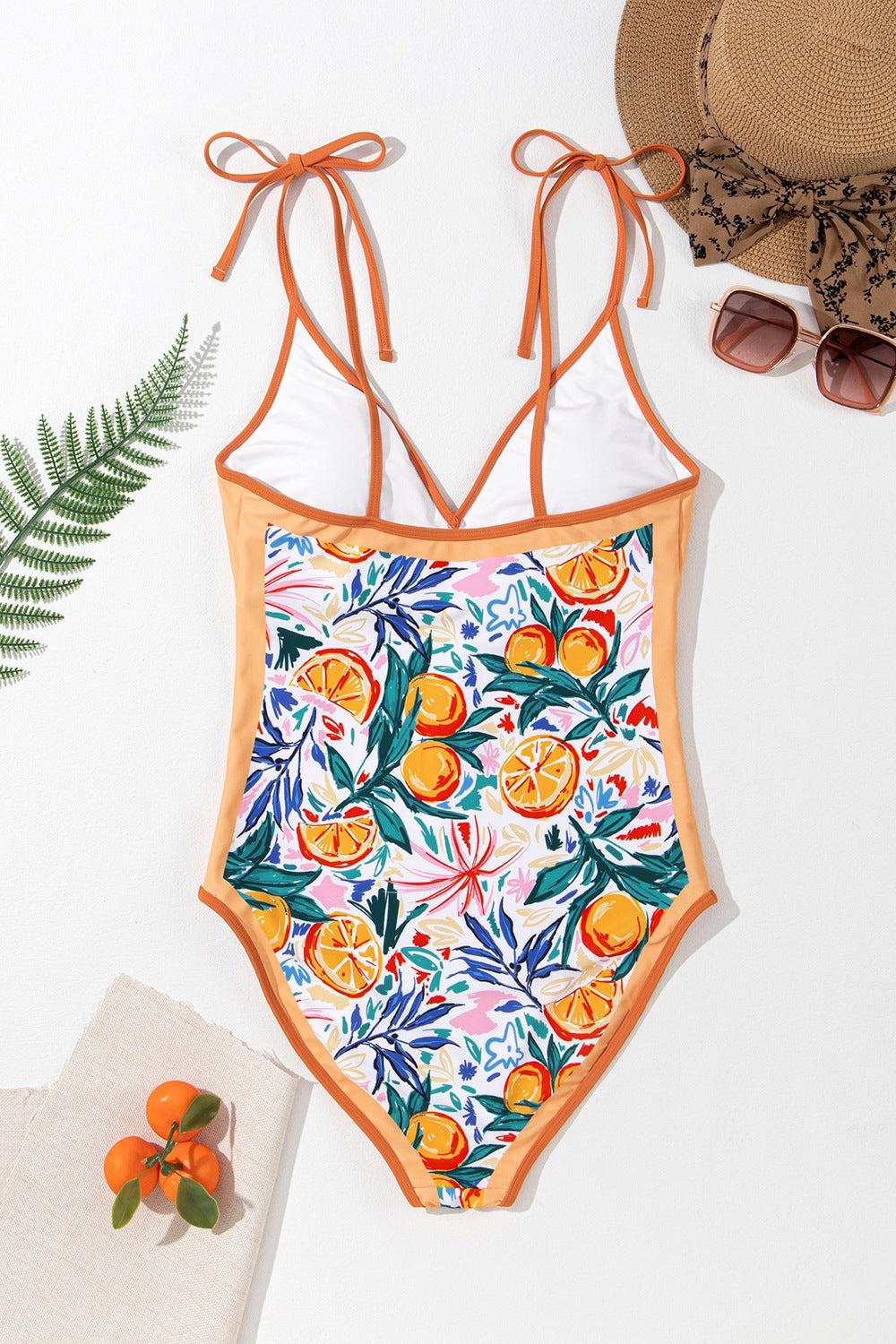 a women's one piece swimsuit with oranges on it