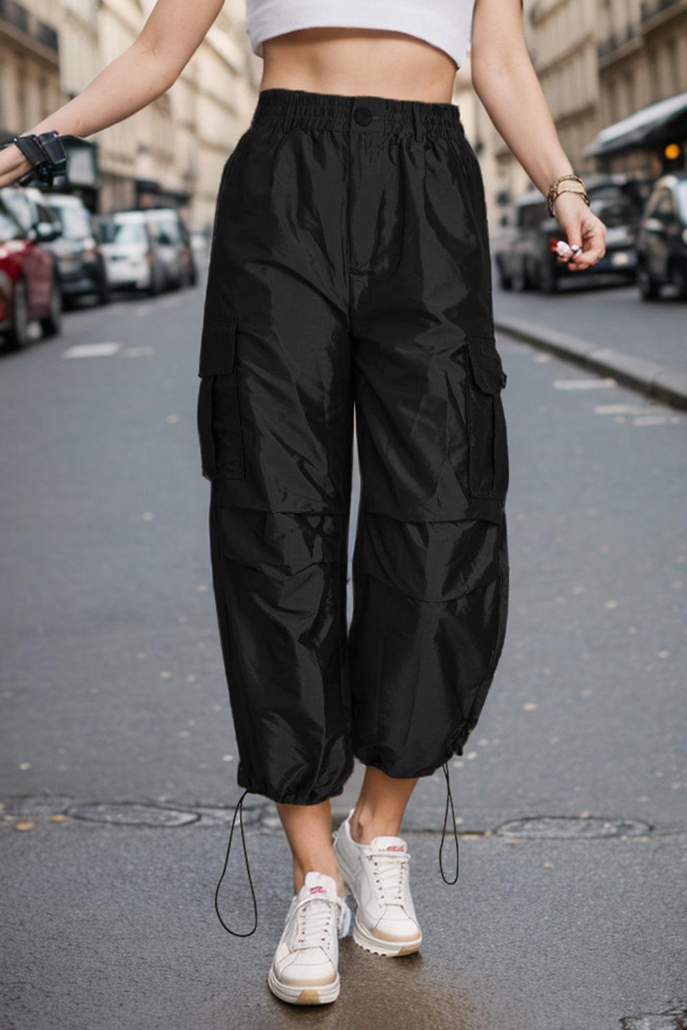 a woman standing on a street with her hands in her pockets