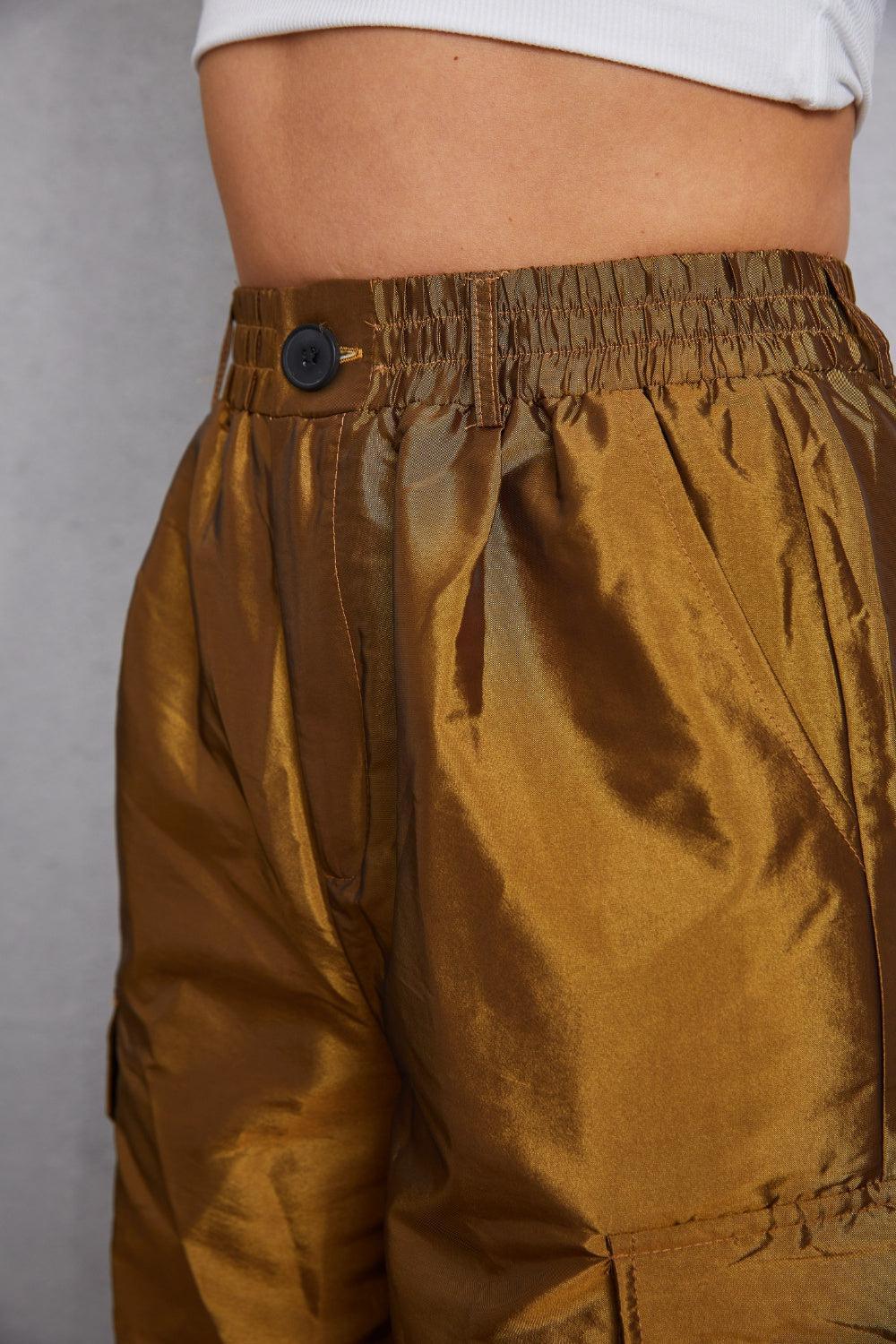 a close up of a person's gold pants