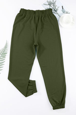 a pair of green pants next to a cup of coffee