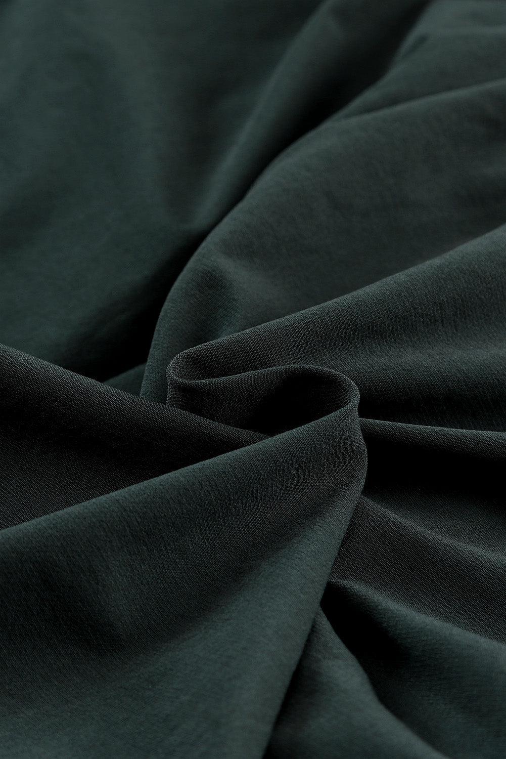 a close up of a dark green fabric