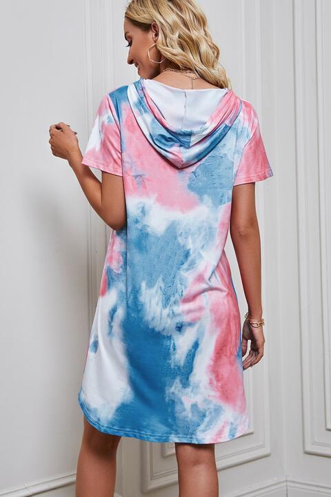 a woman wearing a pink and blue tie dye dress