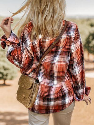 a woman with blonde hair wearing a plaid shirt