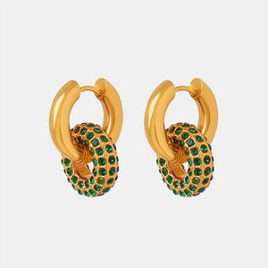 a pair of gold earrings with green stones