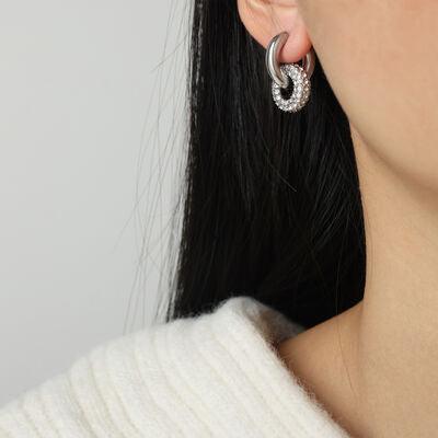 a close up of a person wearing a pair of earrings