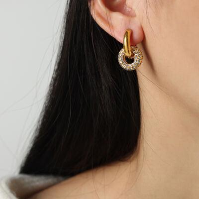 a close up of a person wearing a pair of earrings