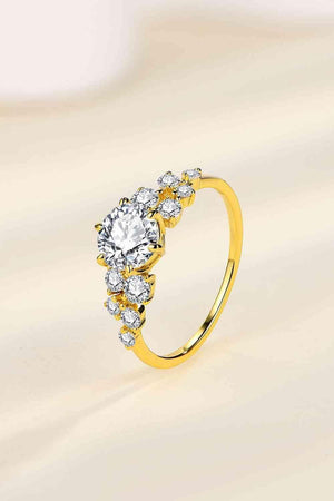 a yellow gold ring with three diamonds