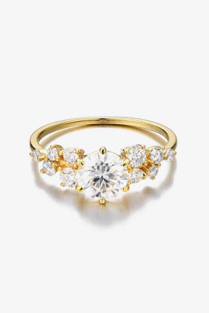 a yellow gold ring with a diamond center