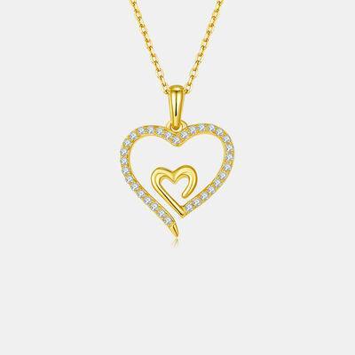 a gold heart pendant with two hearts on a chain