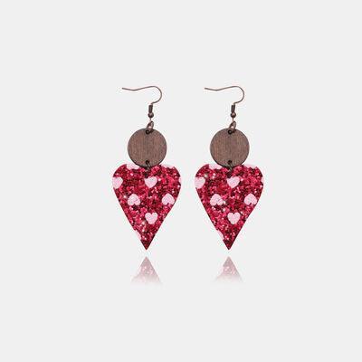 a pair of red and pink heart shaped earrings