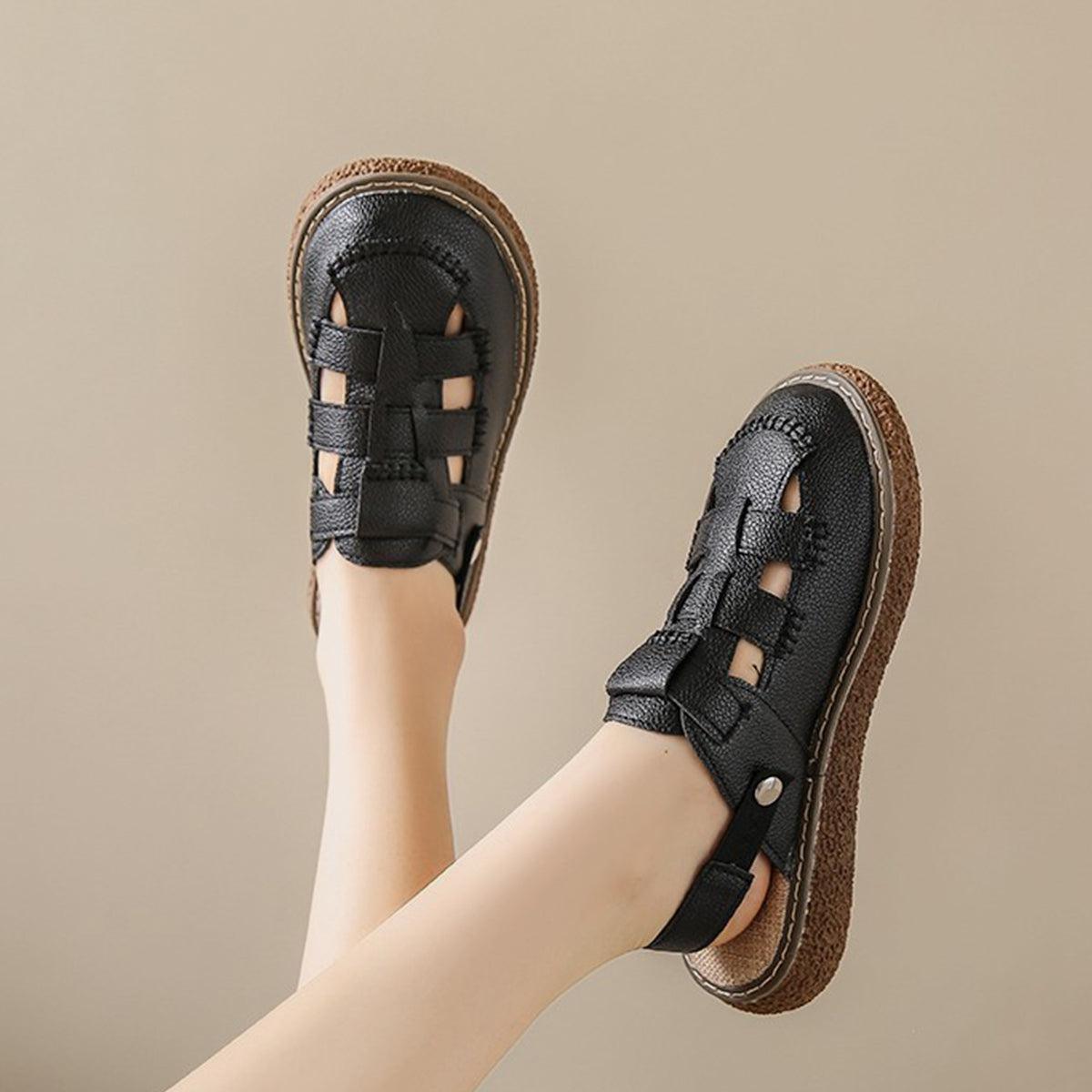 a woman's feet wearing black sandals