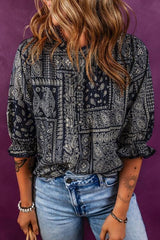 a woman with long hair wearing a black and white shirt