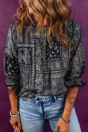 a woman with long hair wearing a black and white shirt