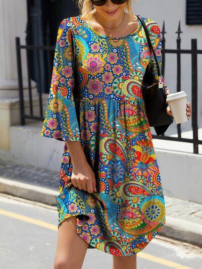 a woman walking down the street in a colorful dress