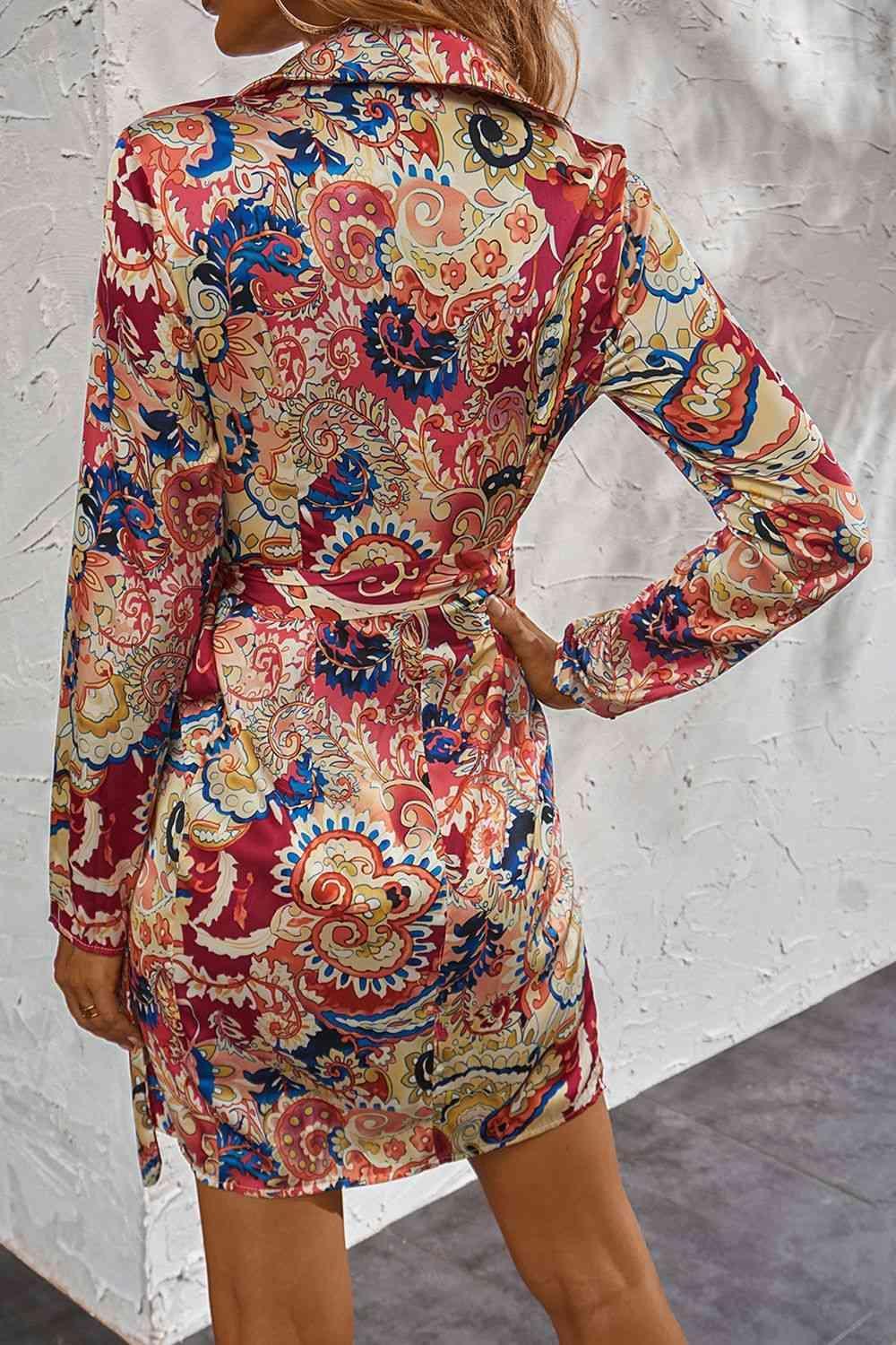 a woman wearing a red and blue paisley print dress