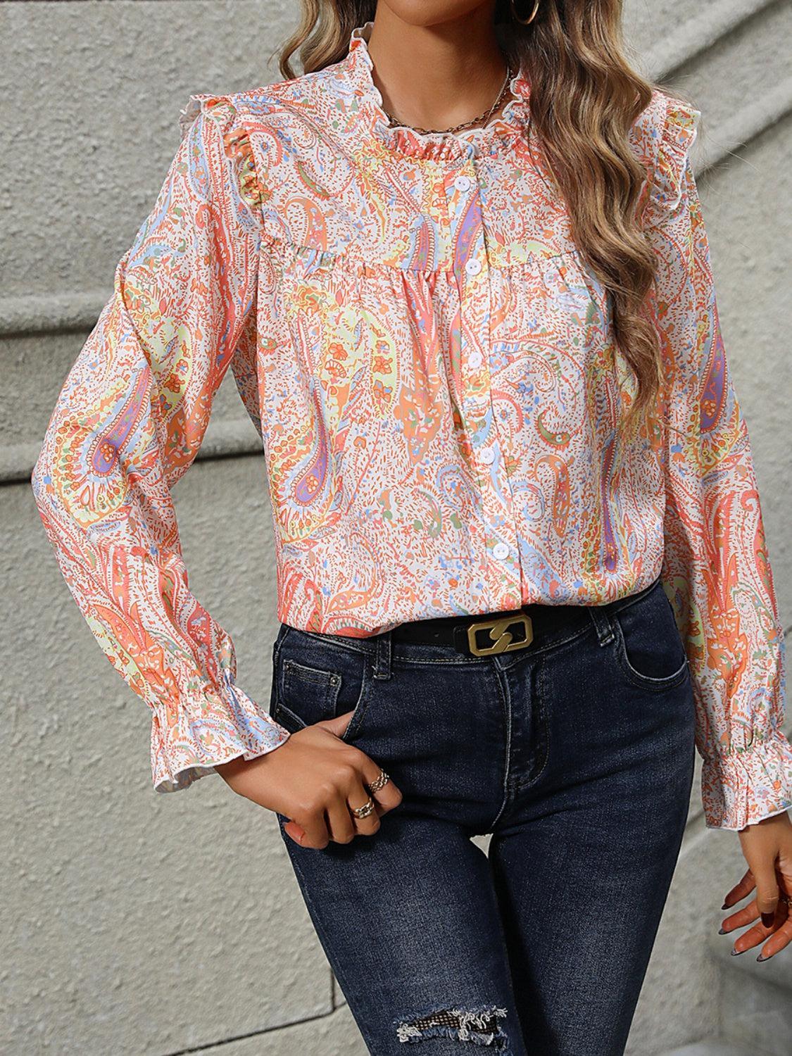 a woman wearing a blouse and jeans posing for a picture