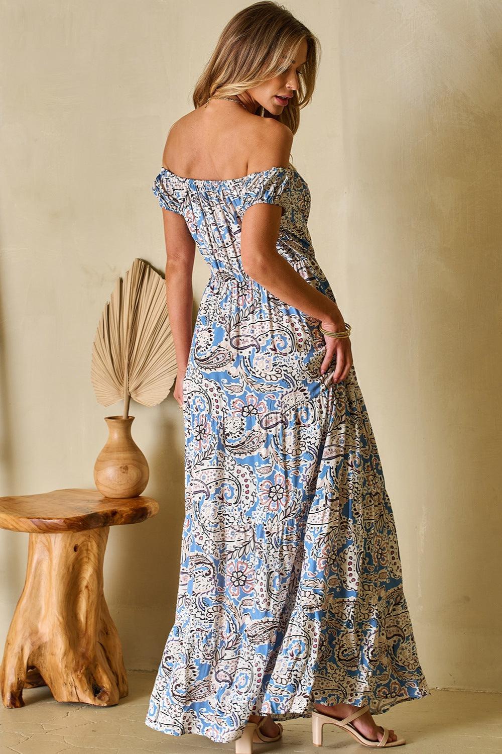 a woman in a blue and white floral print dress