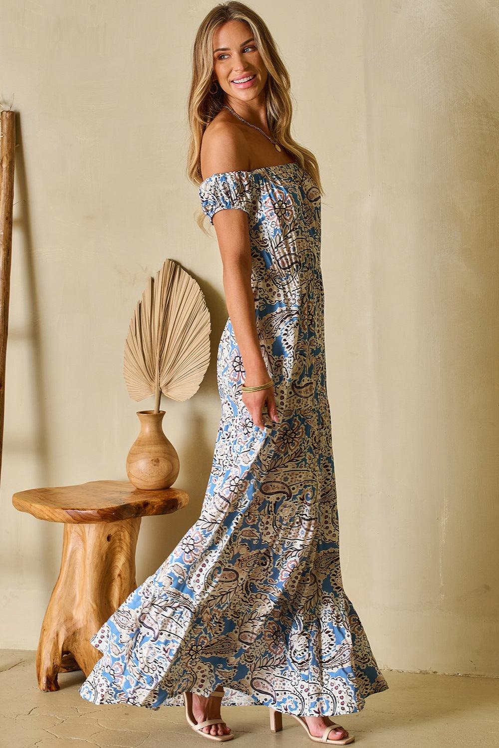 a woman in a blue and white floral print dress