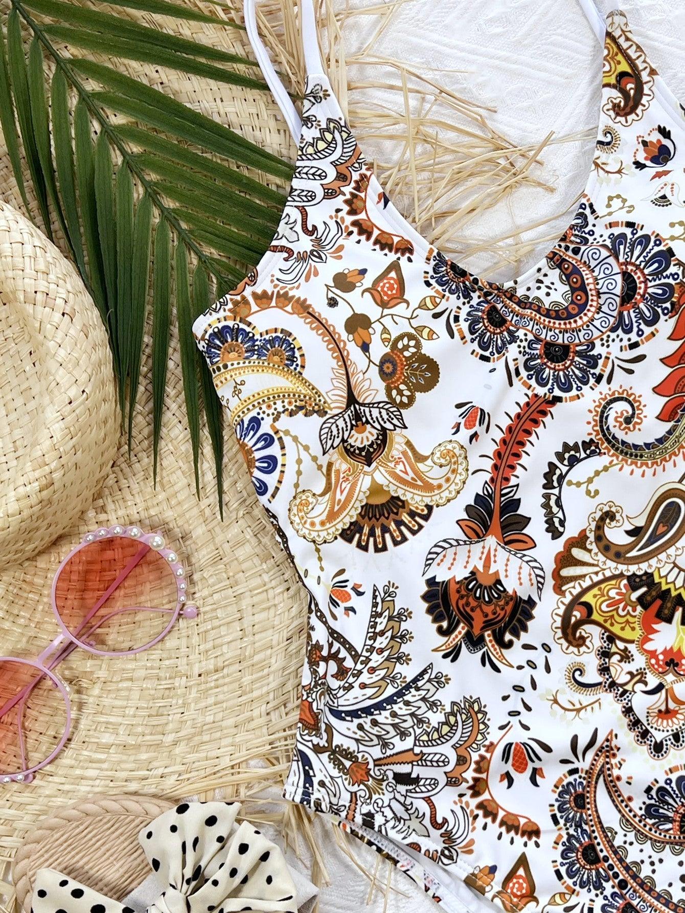a bathing suit and sunglasses on a beach