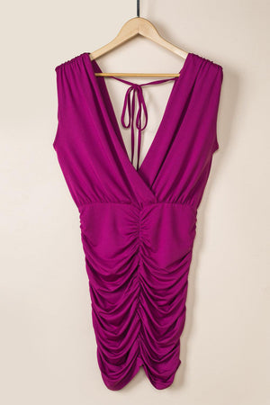 a purple dress hanging on a hanger