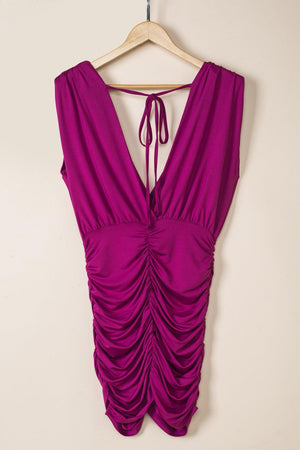 a purple dress hanging on a hanger