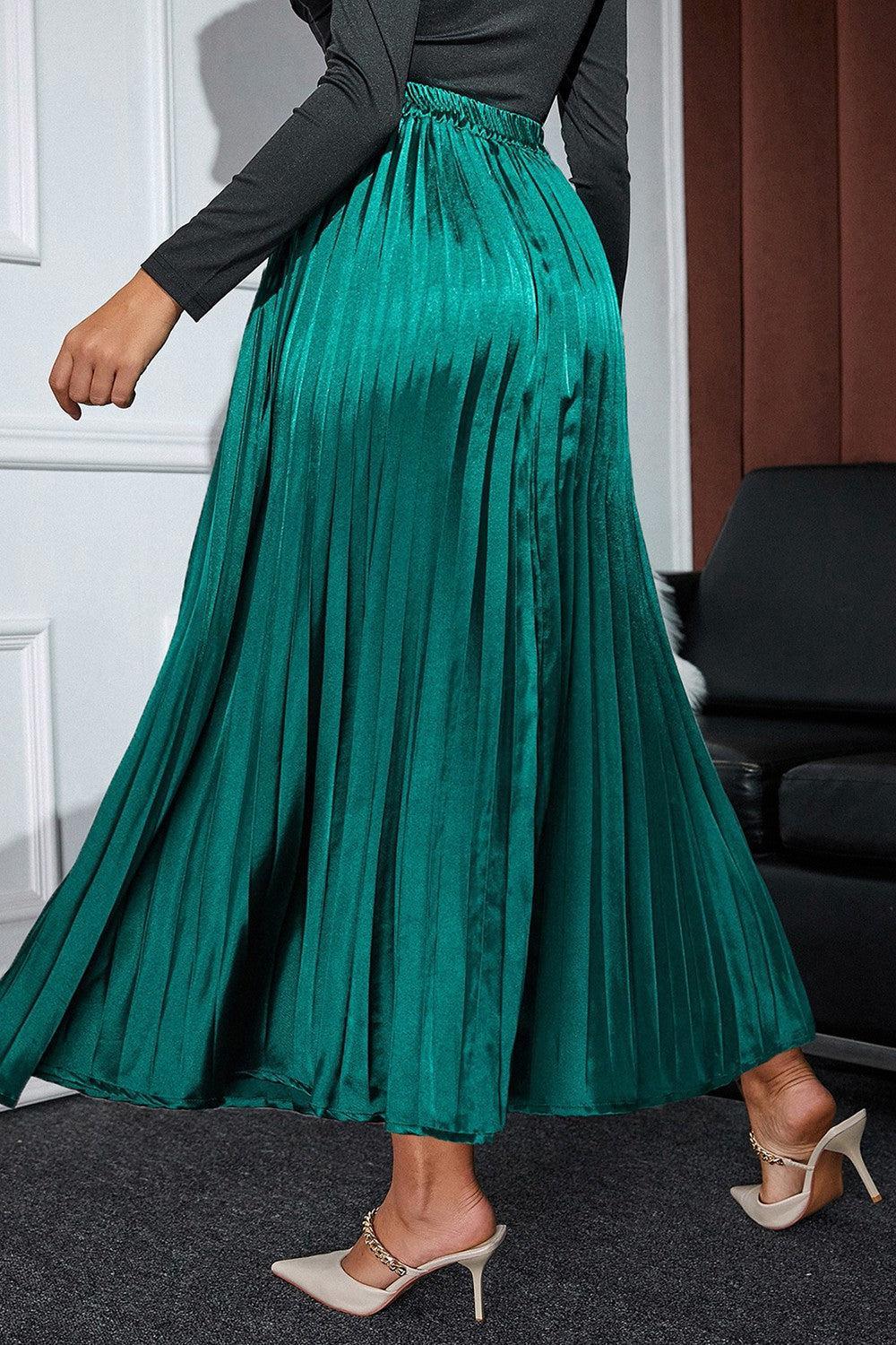 a woman wearing a green pleated skirt
