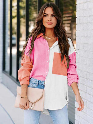 a woman wearing a pink and white shirt and jeans