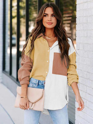 a woman standing next to a white brick wall