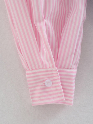 a pink and white striped shirt with a button