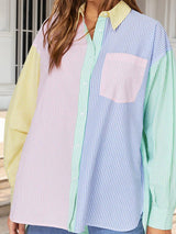 a woman wearing a colorful shirt and jeans