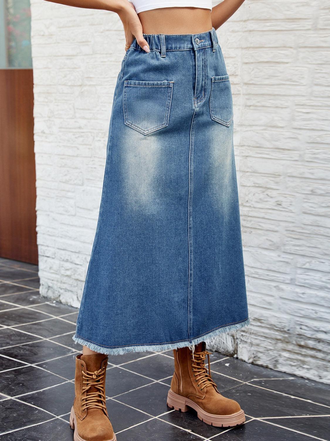 a woman in a white top and a denim skirt