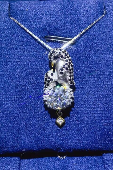 a necklace with a white diamond on a blue cloth