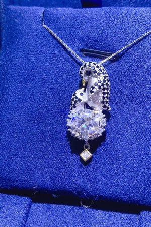 a necklace that is sitting on a blue cloth