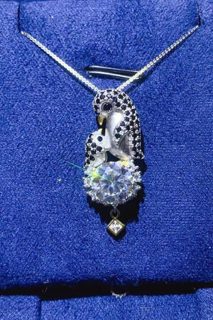 a necklace with a skull and a diamond on it